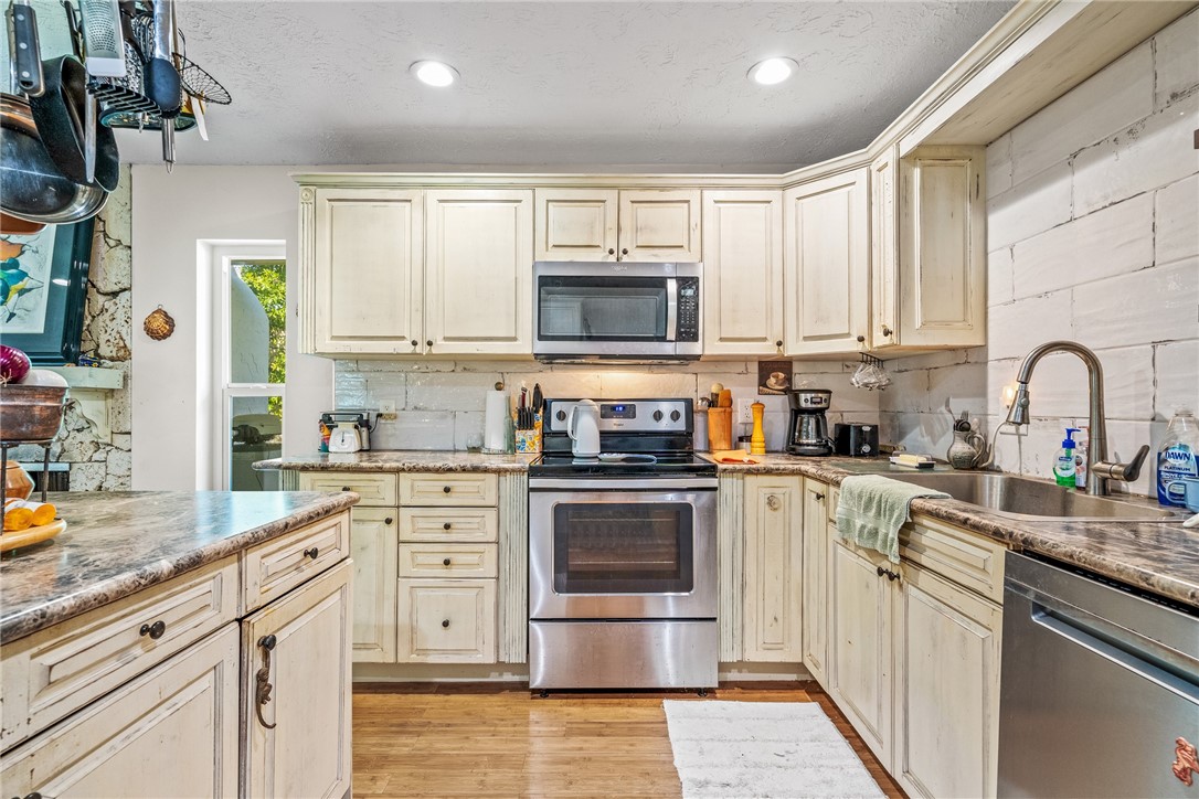 5313 Palm Drive Fort Pierce, FL 34982 - Photo 16 of 36 a kitchen with stainless steel appliances granite countertop a stove a sink and a microwave
