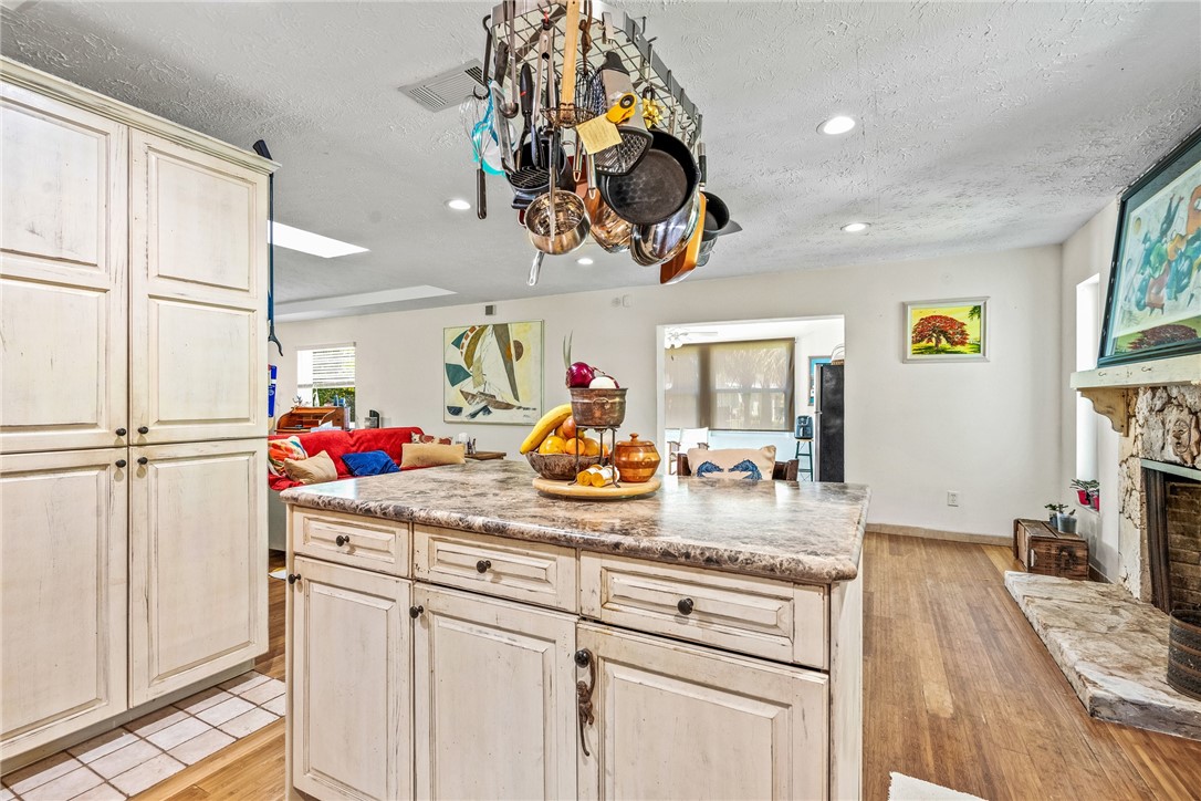 5313 Palm Drive Fort Pierce, FL 34982 - Photo 18 of 36 a kitchen with white cabinets and chandelier