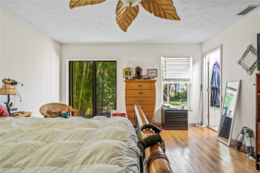 5313 Palm Drive Fort Pierce, FL 34982 - Photo 28 of 36 a bedroom with a bed and a large window
