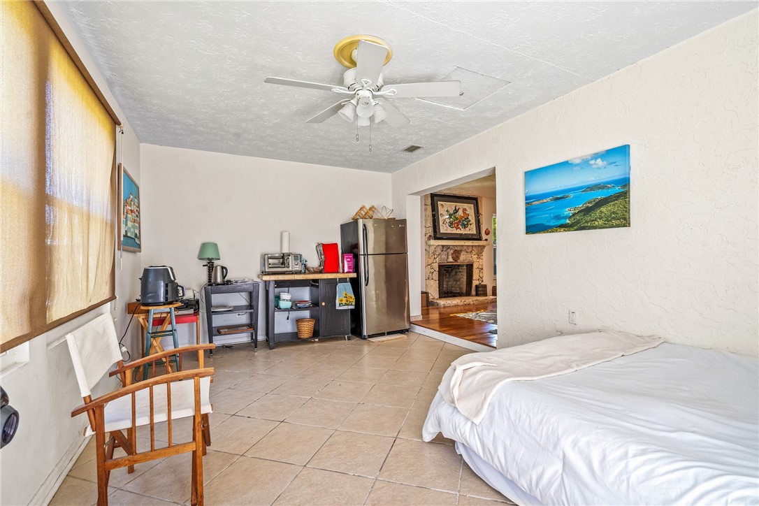 5313 Palm Drive Fort Pierce, FL 34982 - Photo 31 of 36 a bedroom with a bed and a chandelier