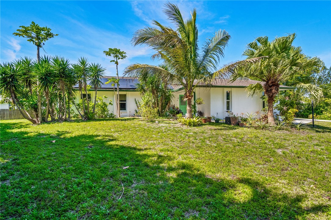 5313 Palm Drive Fort Pierce, FL 34982 - Photo 34 of 36 a front view of a house with a yard