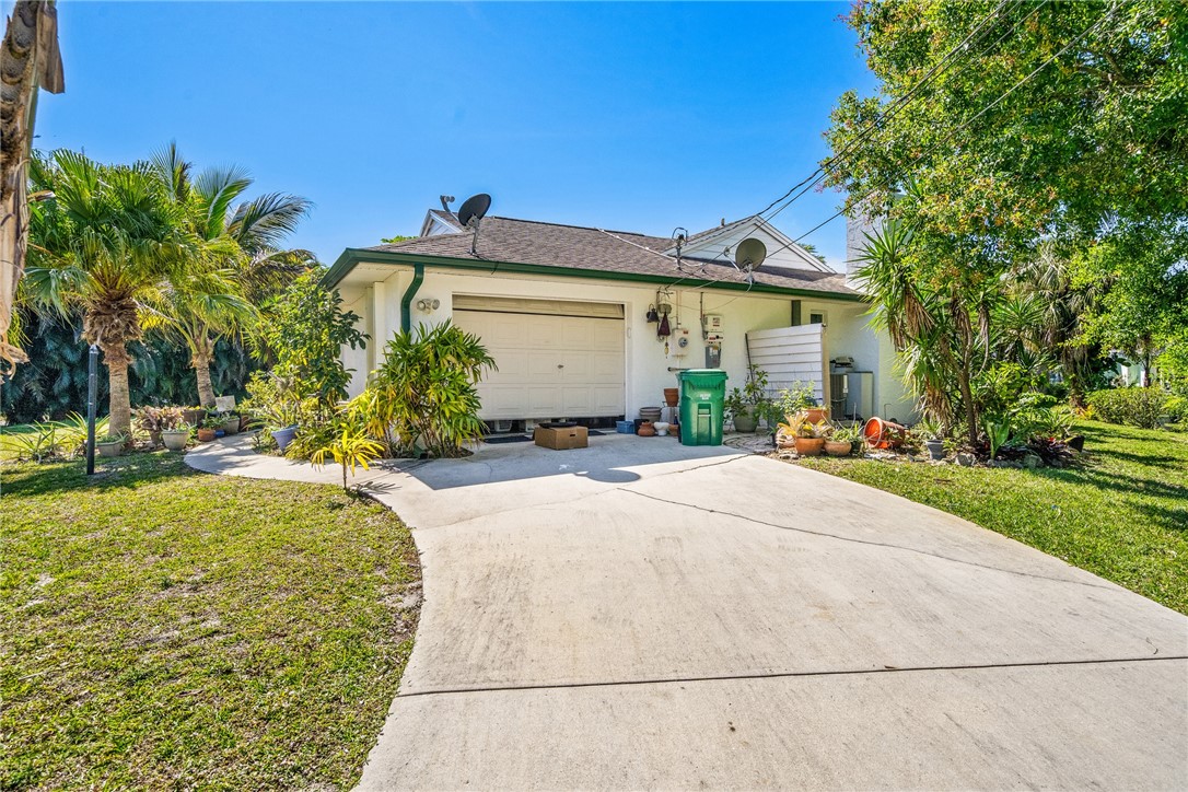 5313 Palm Drive Fort Pierce, FL 34982 - Photo 36 of 36 a front view of a house with a yard and garage