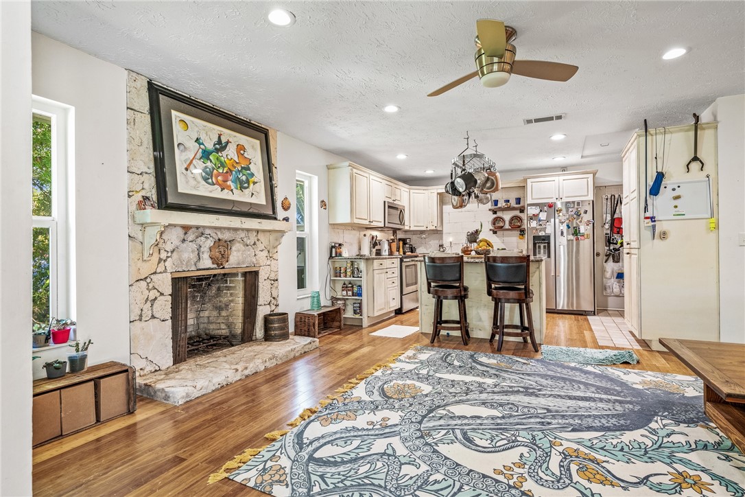 5313 Palm Drive Fort Pierce, FL 34982 - Photo 10 of 36 a view of a livingroom with furniture a fireplace wooden floor and chandelier