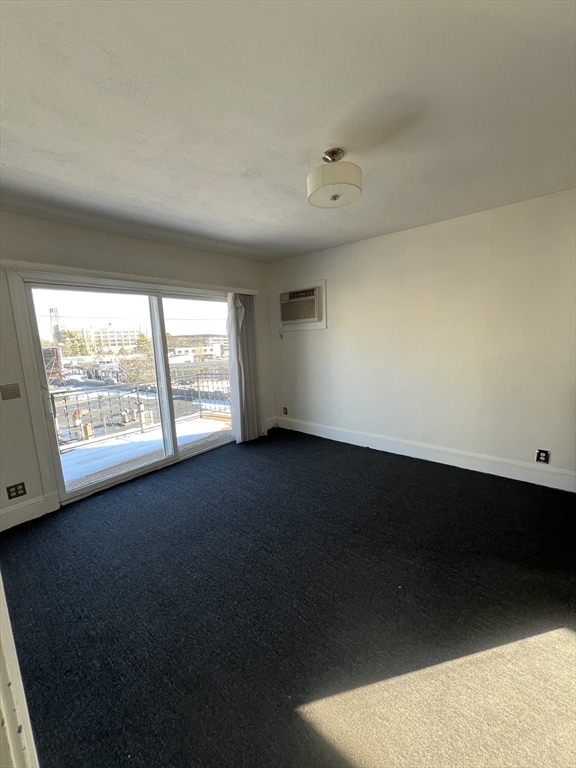 8 Irma Avenue, Unit 2 Watertown, MA 02472 - Photo 1 of 20 wooden floor in an empty room with a window
