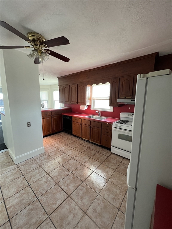 8 Irma Avenue, Unit 2 Watertown, MA 02472 - Photo 11 of 20 a kitchen with stainless steel appliances a refrigerator and a sink