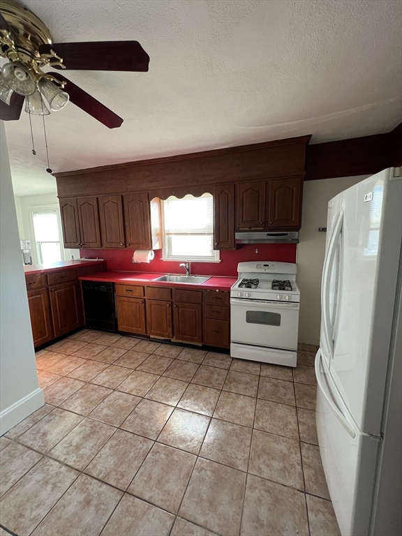 8 Irma Avenue, Unit 2 Watertown, MA 02472 - Photo 13 of 20 a kitchen with a cabinets and white stainless steel appliances