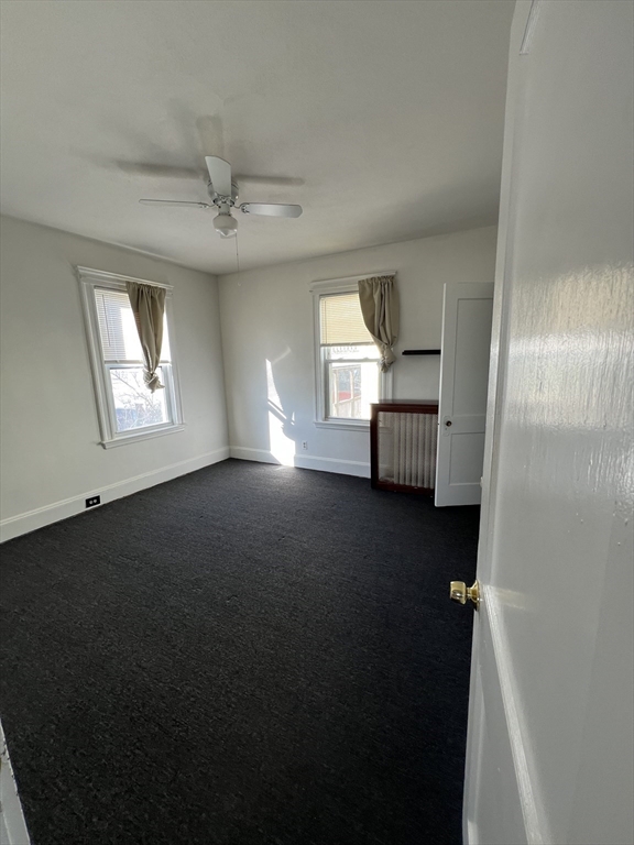 8 Irma Avenue, Unit 2 Watertown, MA 02472 - Photo 14 of 20 wooden floor in an empty room with a window
