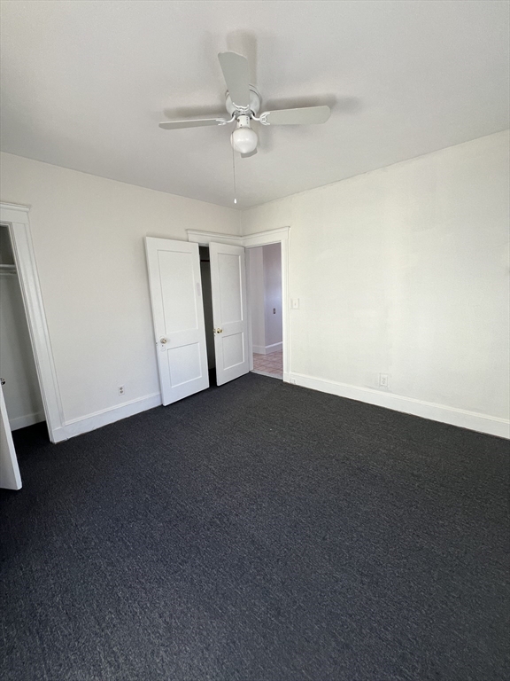 8 Irma Avenue, Unit 2 Watertown, MA 02472 - Photo 16 of 20 an empty room with a ceiling fan and window