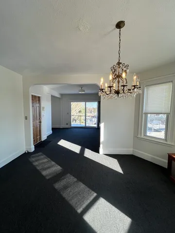 a view of a chairs and table in the balcony