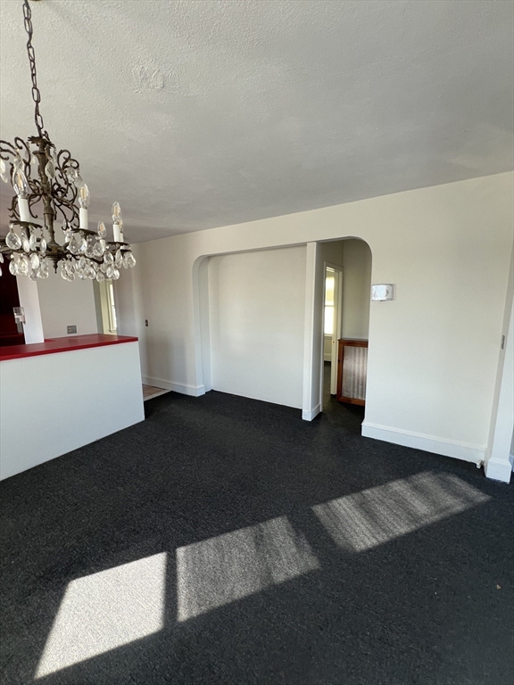 8 Irma Avenue, Unit 2 Watertown, MA 02472 - Photo 5 of 20 a view of empty room with wooden floor