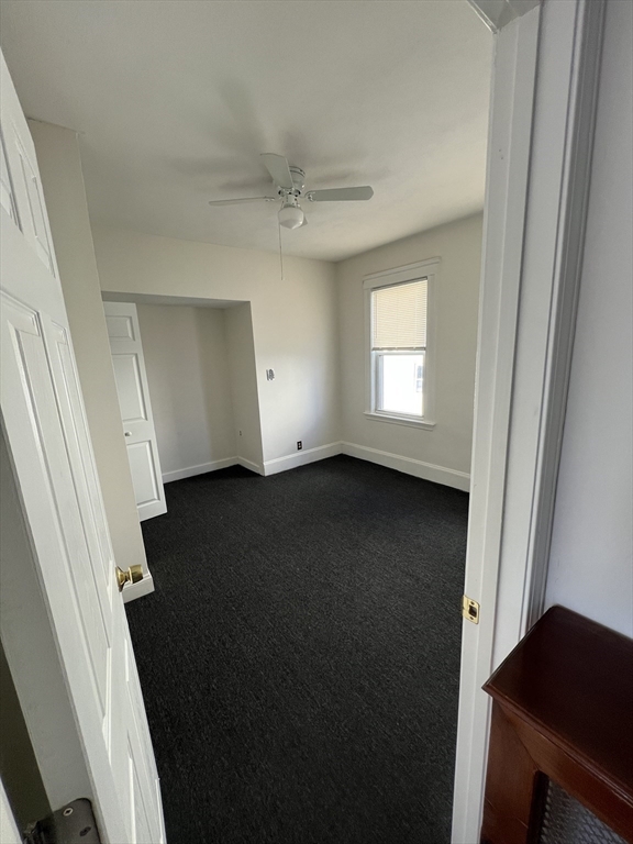 8 Irma Avenue, Unit 2 Watertown, MA 02472 - Photo 7 of 20 an empty room with wooden floor and windows