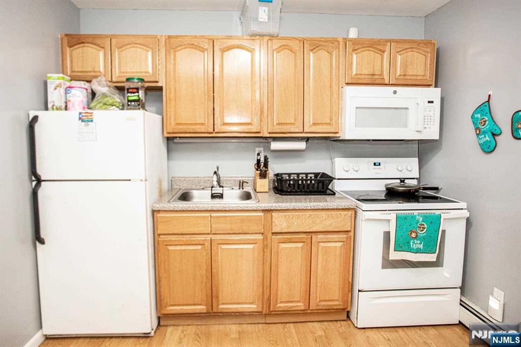 14 Green Court Lodi, NJ 07644 - Photo 2 of 7 a kitchen with a refrigerator and a stove