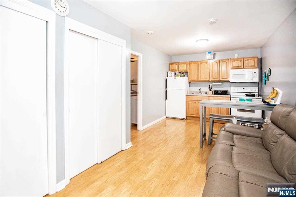 14 Green Court Lodi, NJ 07644 - Photo 3 of 7 a living room with stainless steel appliances kitchen island granite countertop furniture and a refrigerator