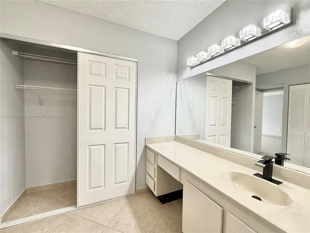 a bathroom with a sink vanity and a mirror