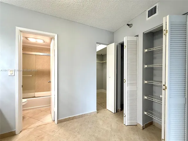 a view of closet area with empty racks