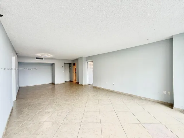 a kitchen with a refrigerator and a more cabinets