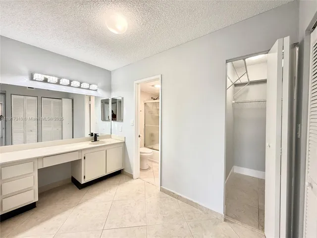 a view of bathroom with a glass door shower
