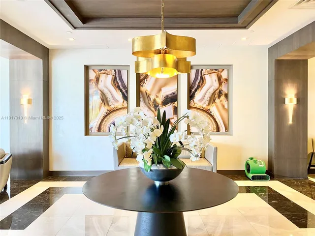 a living room with fireplace furniture and large windows