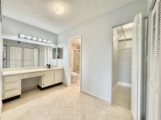 a large white bathroom with a large tub sink and shower