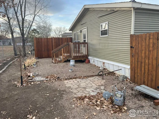 a view of house with backyard and wooden fence