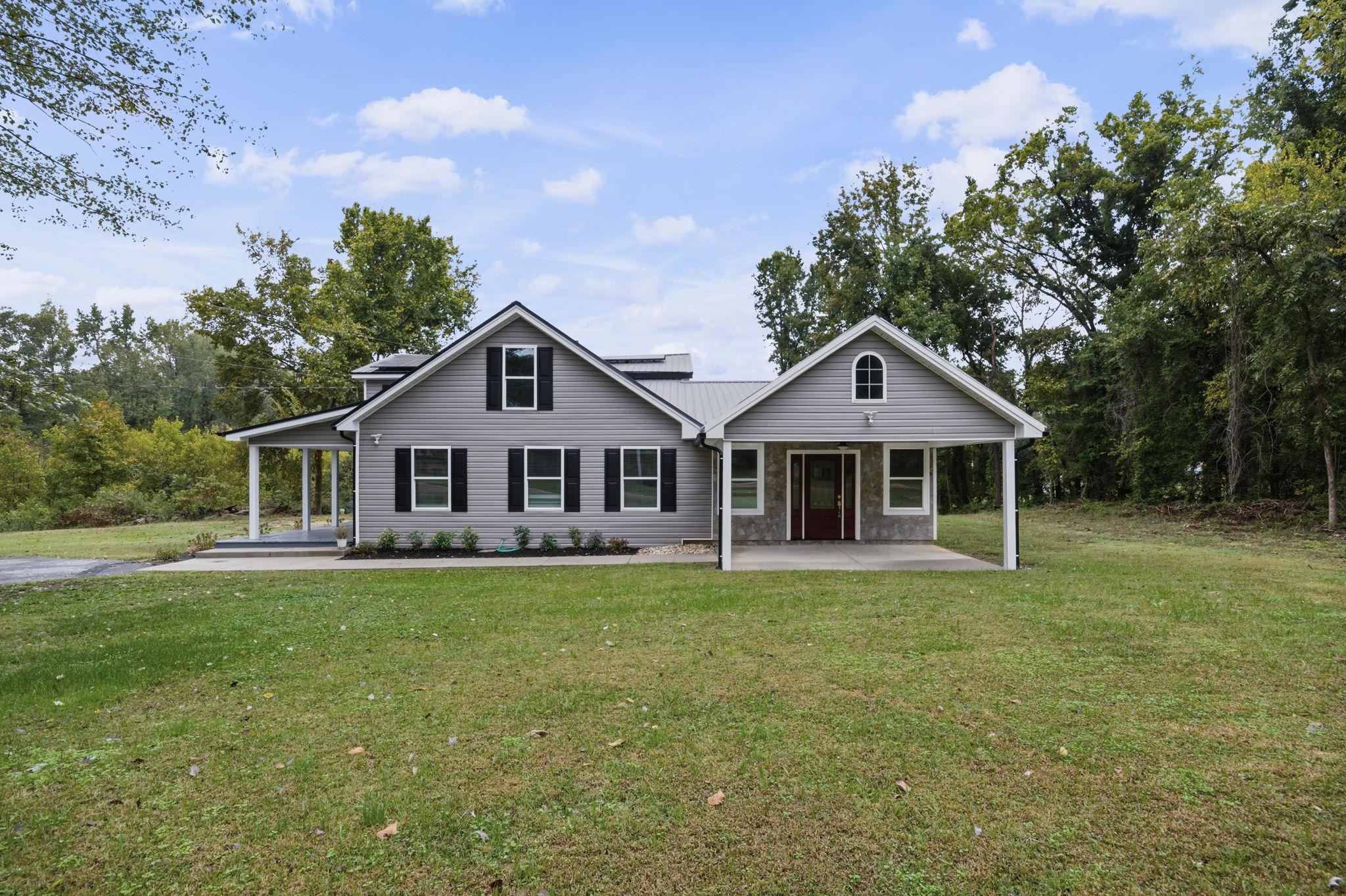 a front view of a house with a garden