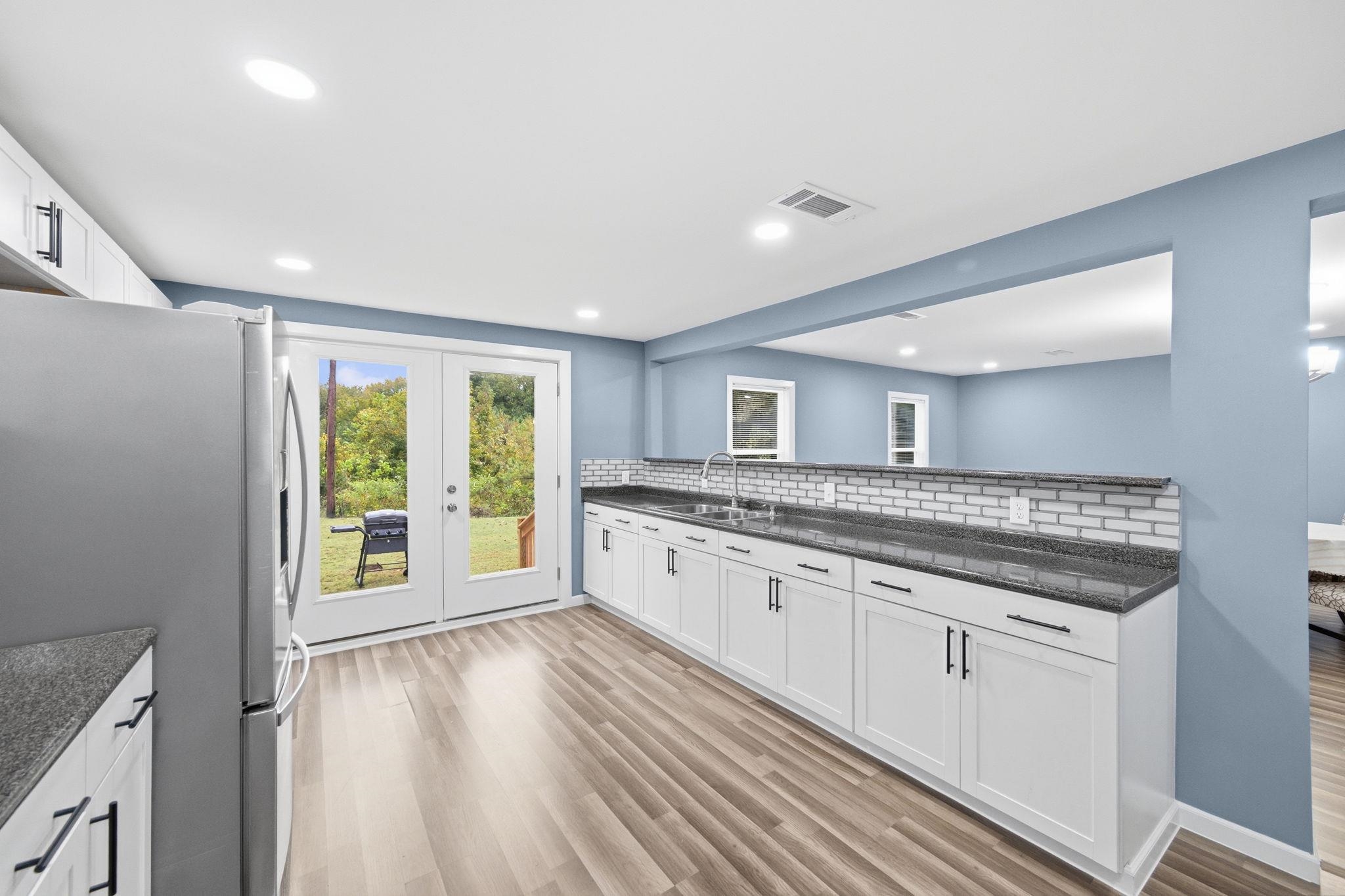9509 Merrill Road Millington, TN 38053 - Photo 12 of 26 a spacious bathroom with a granite countertop sink and a large mirror