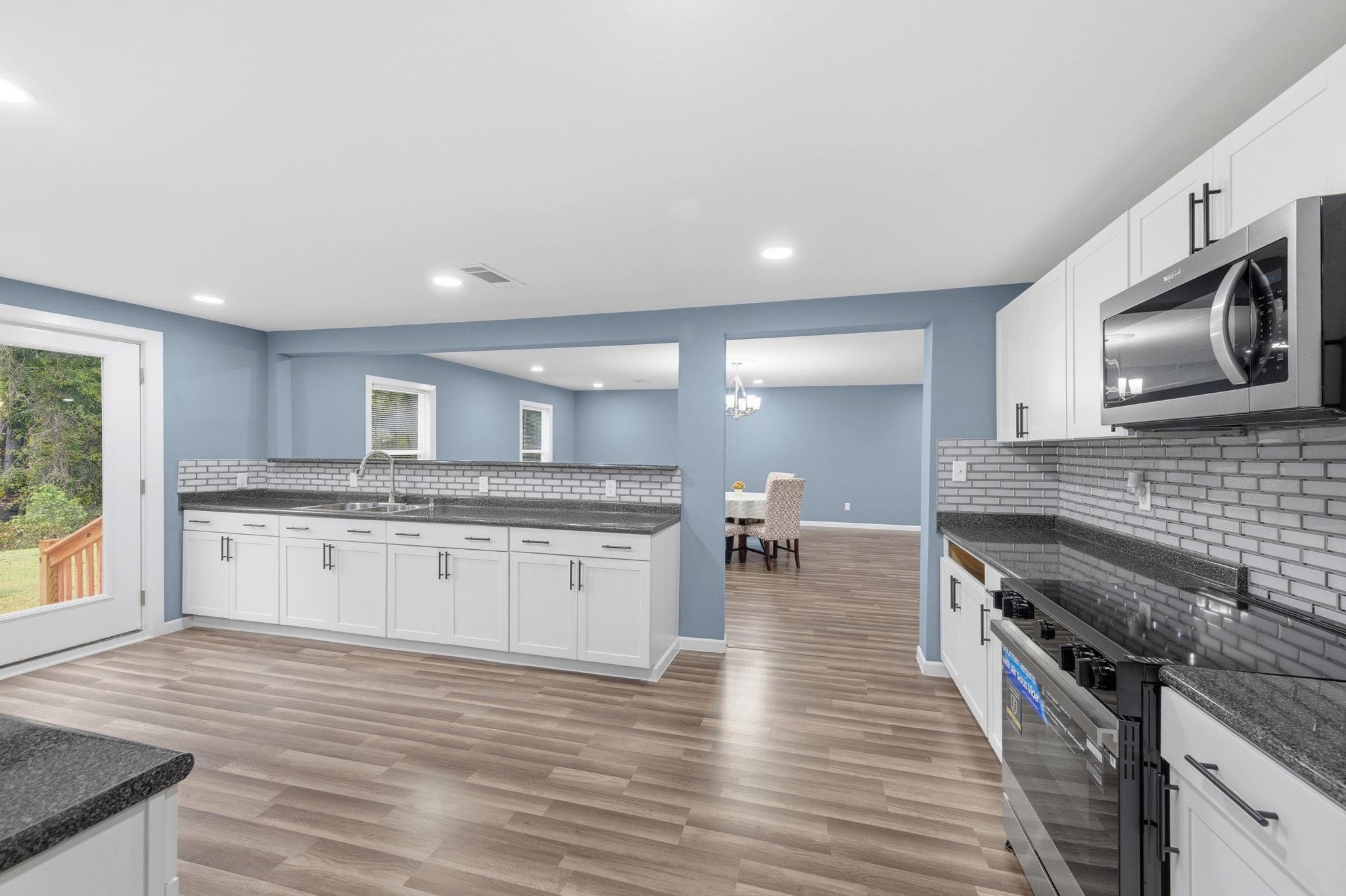 9509 Merrill Road Millington, TN 38053 - Photo 13 of 26 a kitchen with stainless steel appliances granite countertop a stove and a sink