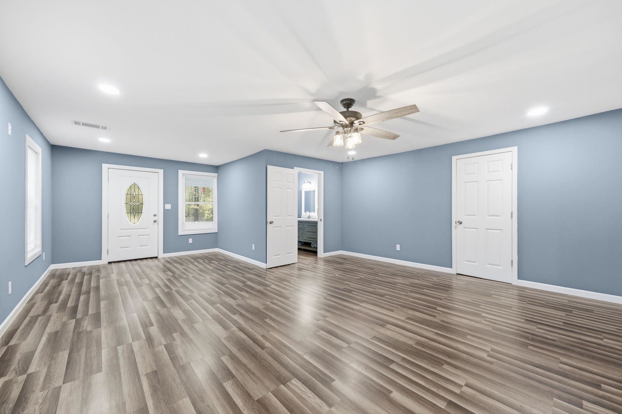 9509 Merrill Road Millington, TN 38053 - Photo 15 of 26 a view of an empty room with wooden floor and window
