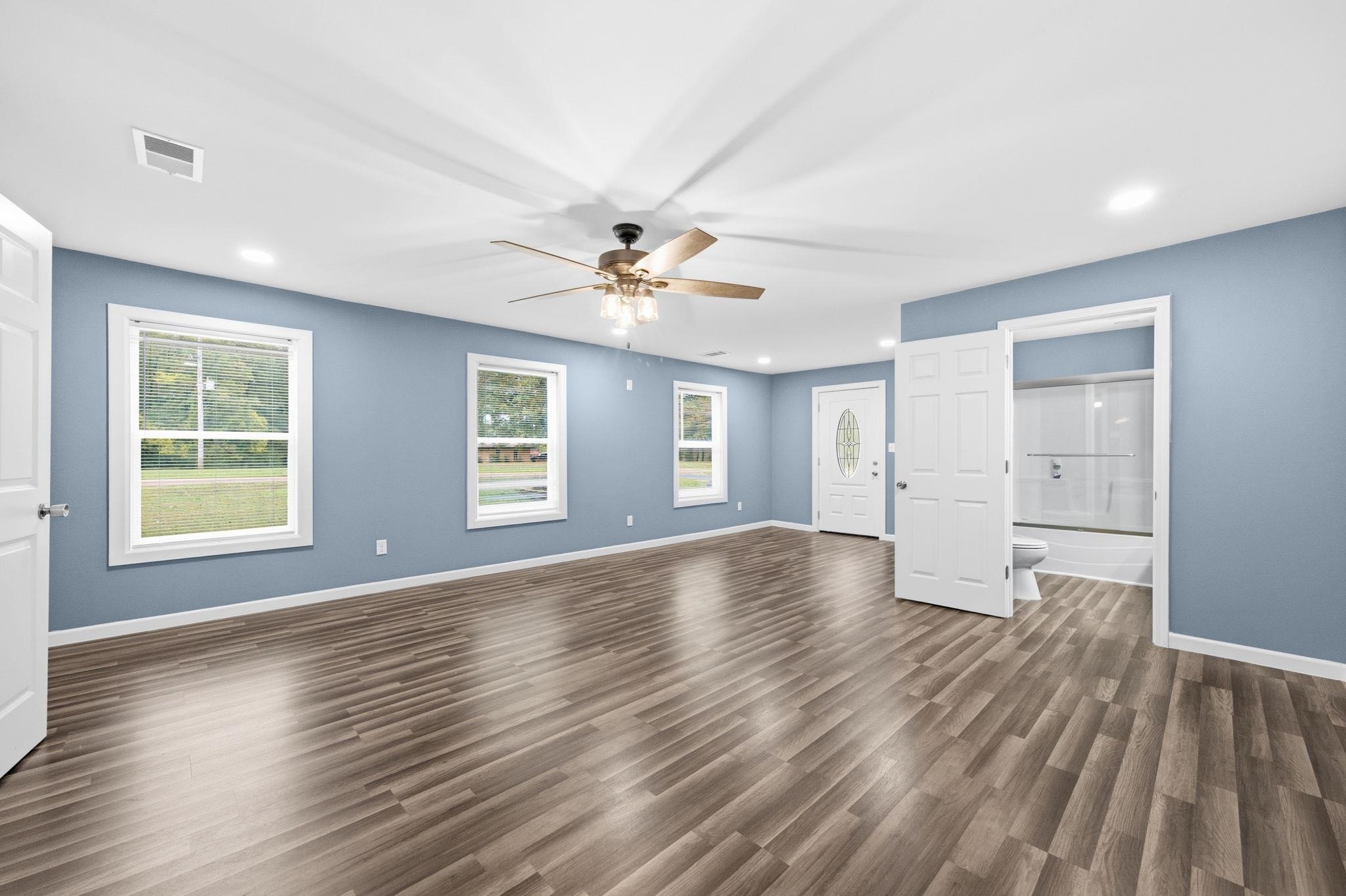 9509 Merrill Road Millington, TN 38053 - Photo 16 of 26 a view of empty room with wooden floor and fan