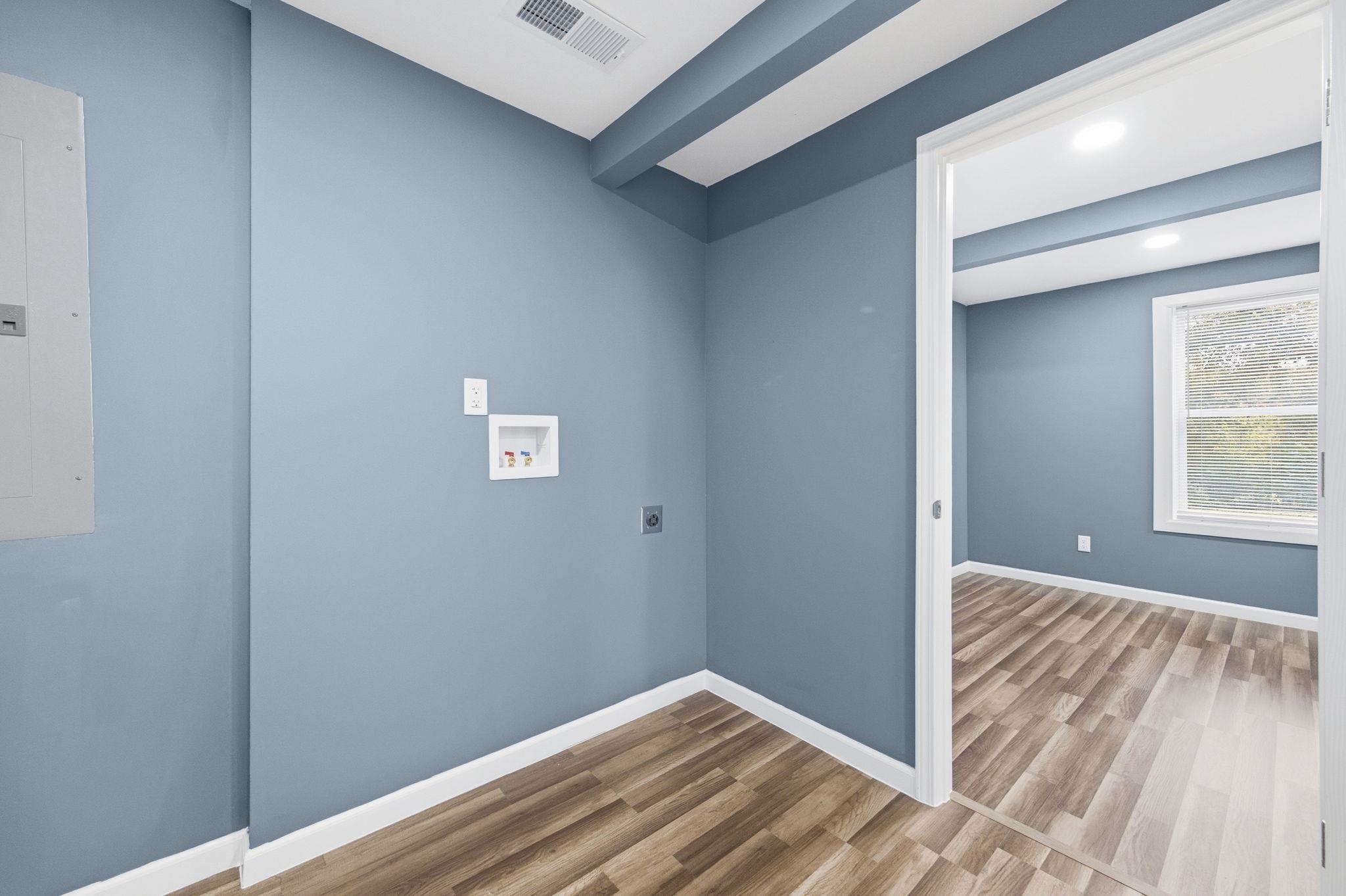 9509 Merrill Road Millington, TN 38053 - Photo 19 of 26 a view of a hallway with wooden floor and a window