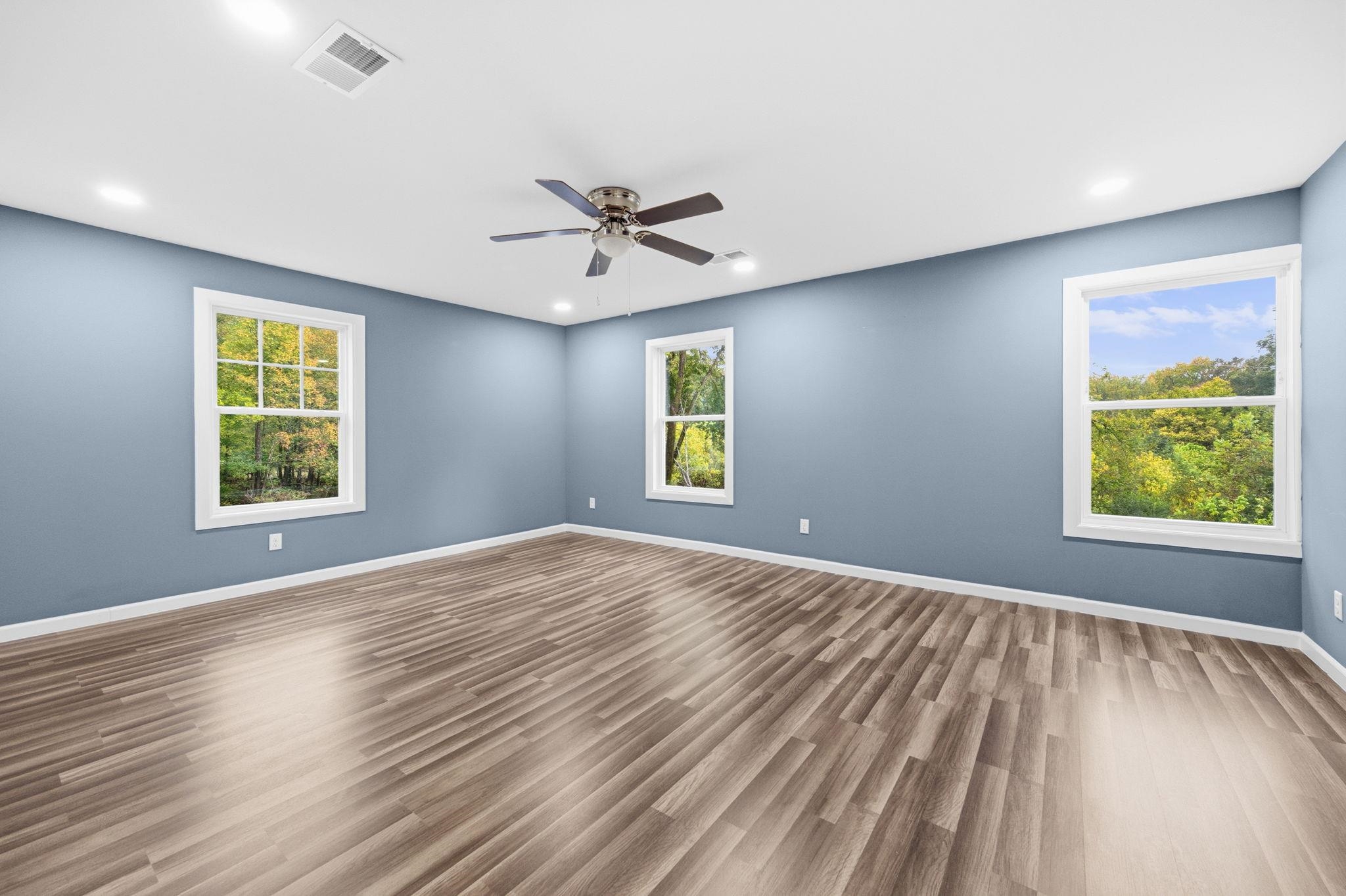 9509 Merrill Road Millington, TN 38053 - Photo 21 of 26 a view of an empty room with a window and wooden floor