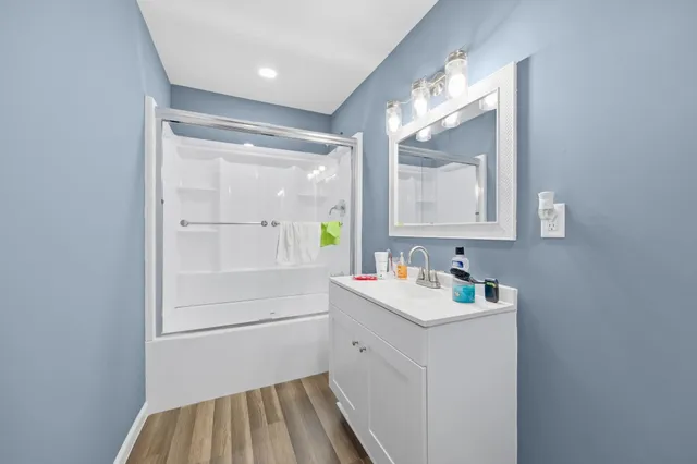 a bathroom with a sink a mirror and a shower
