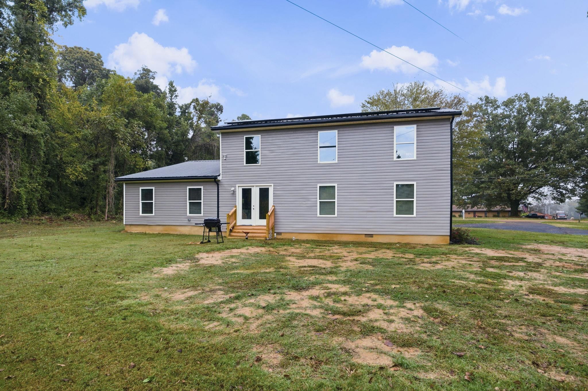 9509 Merrill Road Millington, TN 38053 - Photo 26 of 26 a backyard of a house with table and chairs
