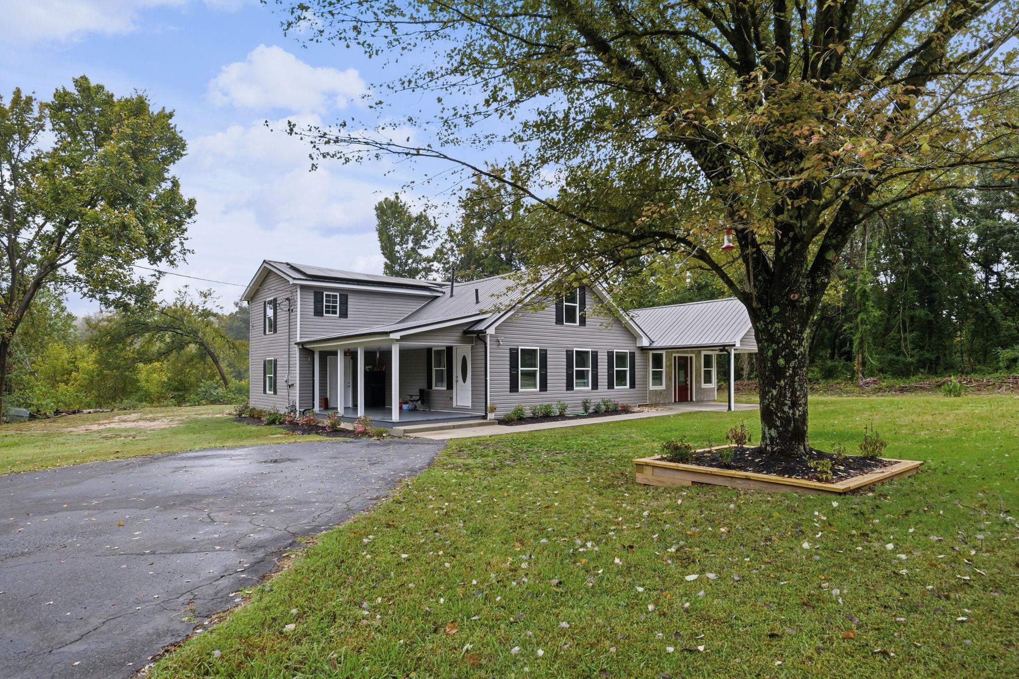 9509 Merrill Road Millington, TN 38053 - Photo 3 of 26 a front view of a house with a garden