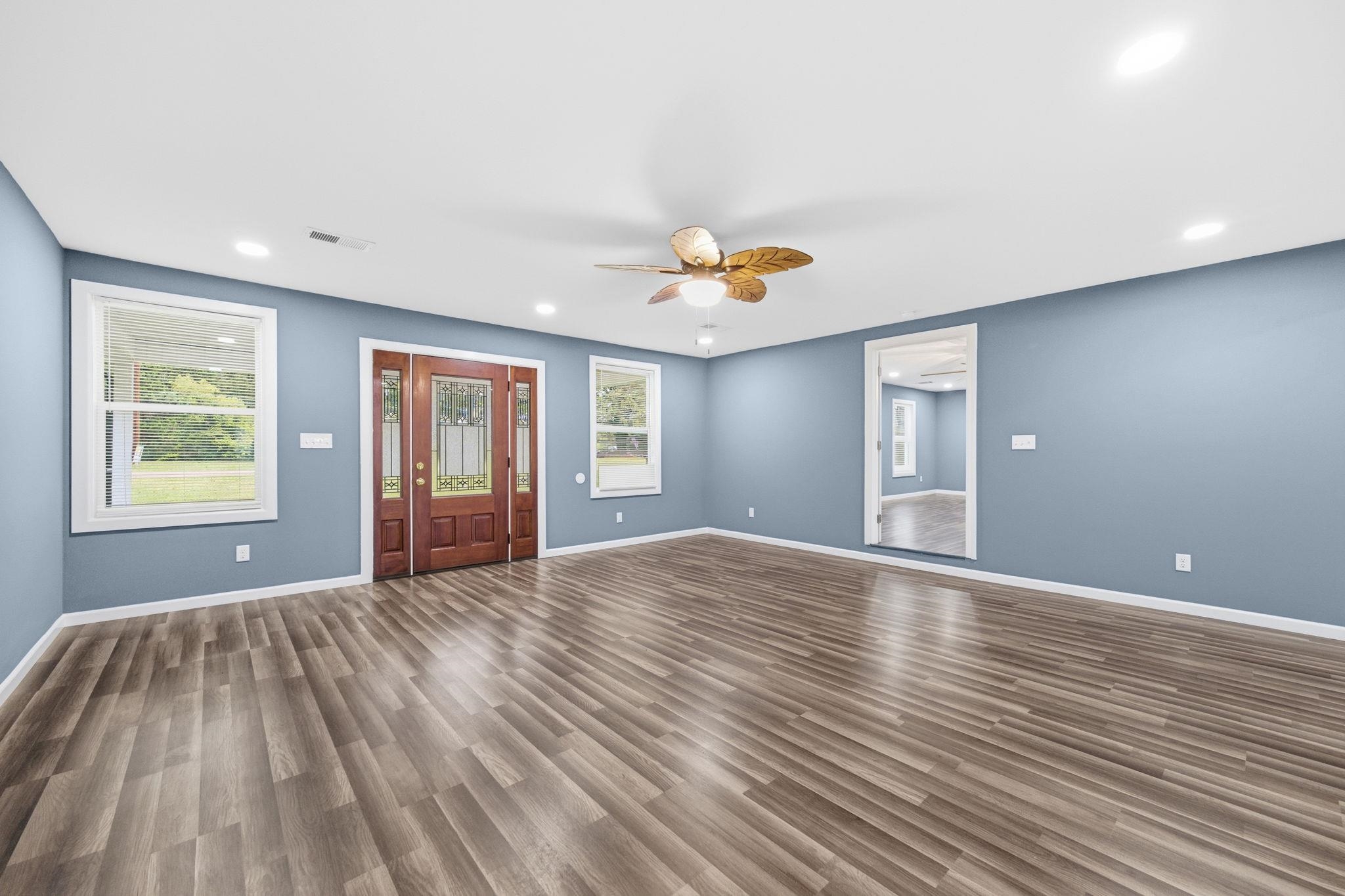 9509 Merrill Road Millington, TN 38053 - Photo 6 of 26 a view of an empty room with window and wooden floor