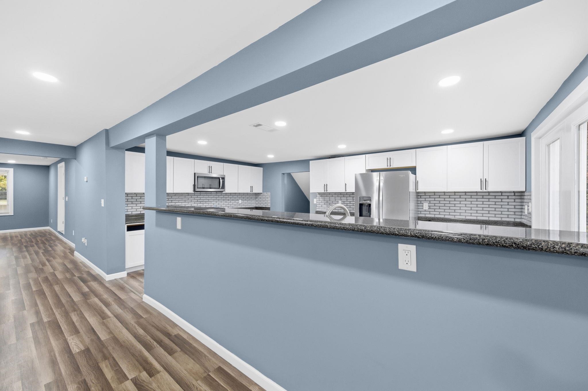 9509 Merrill Road Millington, TN 38053 - Photo 9 of 26 a kitchen with stainless steel appliances a sink stove and cabinets