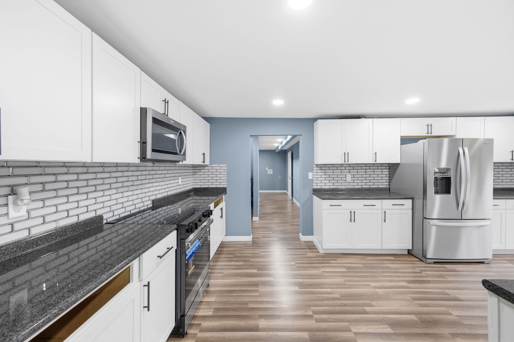 9509 Merrill Road Millington, TN 38053 - Photo 10 of 26 a modern kitchen with stainless steel appliances granite countertop a stove and a refrigerator