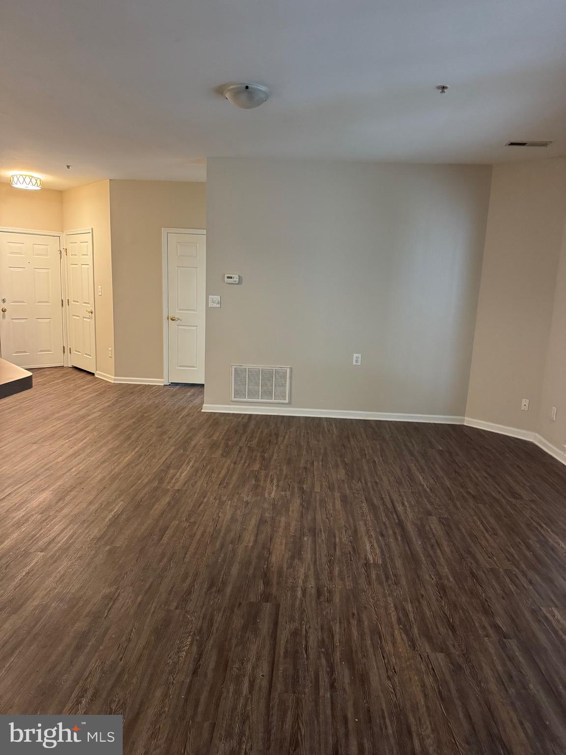 2003 Whispering Ponds Court, Unit 1C Salisbury, MD 21804 - Photo 3 of 12 a view of an empty room with wooden floor