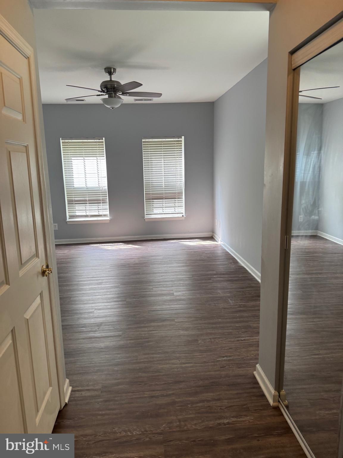 2003 Whispering Ponds Court, Unit 1C Salisbury, MD 21804 - Photo 8 of 12 a view of an empty room with wooden floor and a window