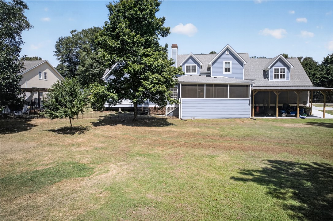 1504 Double Springs Road Townville, SC 29689 - Photo 45 of 49 A spacious grassy lawn stretches behind this multi-level home with a screened porch and carport.