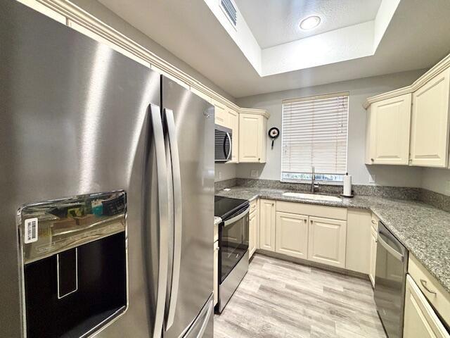 10520 Southwest Stephanie Way, Unit 2202 Port St. Lucie, FL 34987 - Photo 3 of 9 a kitchen with stainless steel appliances granite countertop a stove and a refrigerator