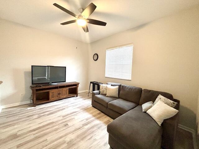 10520 Southwest Stephanie Way, Unit 2202 Port St. Lucie, FL 34987 - Photo 4 of 9 a living room with furniture and a flat screen tv