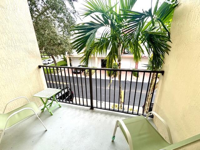 10520 Southwest Stephanie Way, Unit 2202 Port St. Lucie, FL 34987 - Photo 9 of 9 a view of balcony with wooden floor