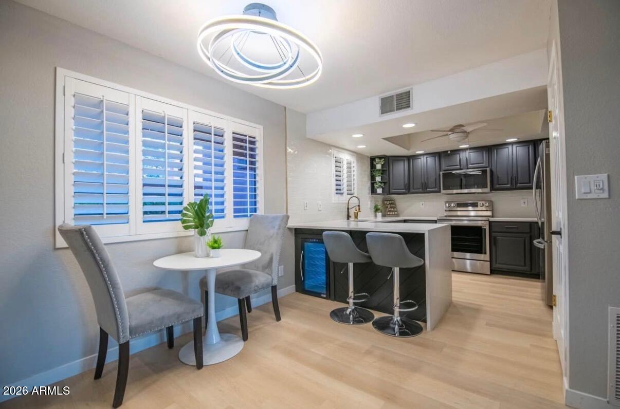 4303 East Cactus Road, Unit 128 Phoenix, AZ 85032 - Photo 21 of 39 a view of a dining room with furniture and a kitchen