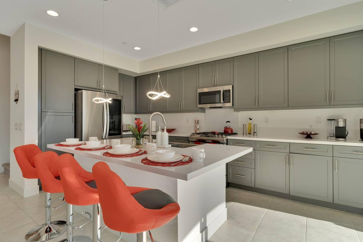 84635 Lago Brezza Drive Indio, CA 92203 - Photo 4 of 39 a kitchen with stainless steel appliances kitchen island granite countertop a dining table and chairs