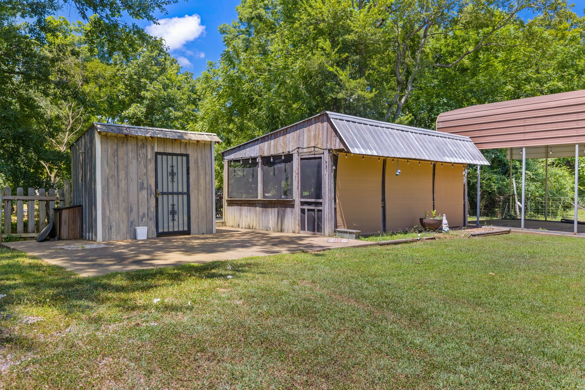 85 Bargeview Lane Adamsville, TN 38310 - Photo 13 of 44 a front view of a house with a garden and trees