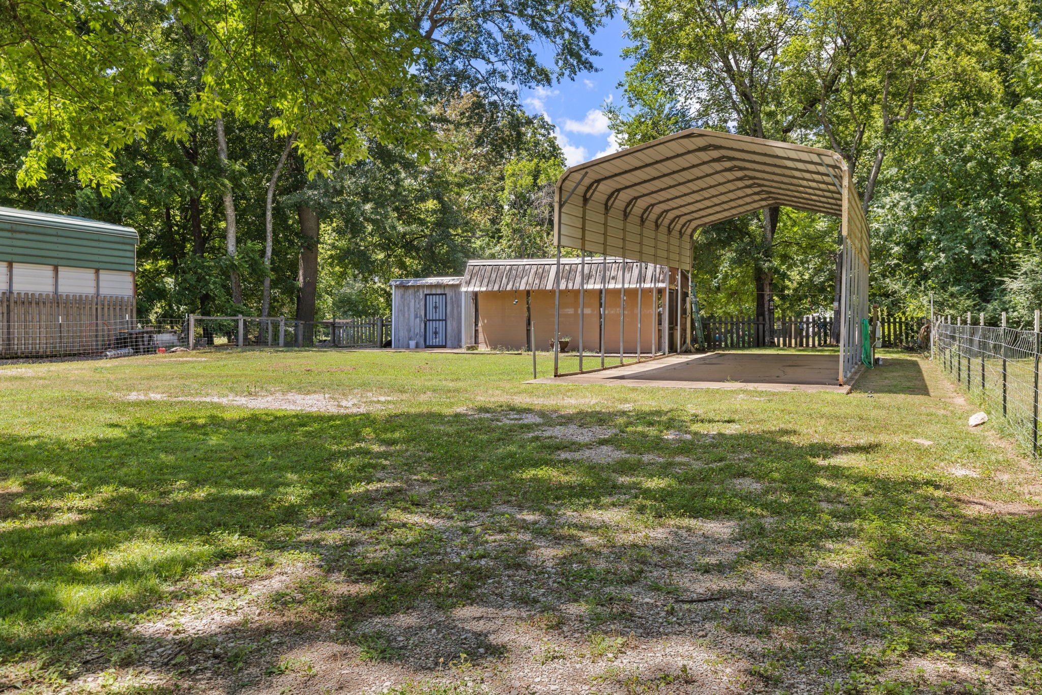 85 Bargeview Lane Adamsville, TN 38310 - Photo 3 of 44 a view of patio with a table and chairs under an umbrella