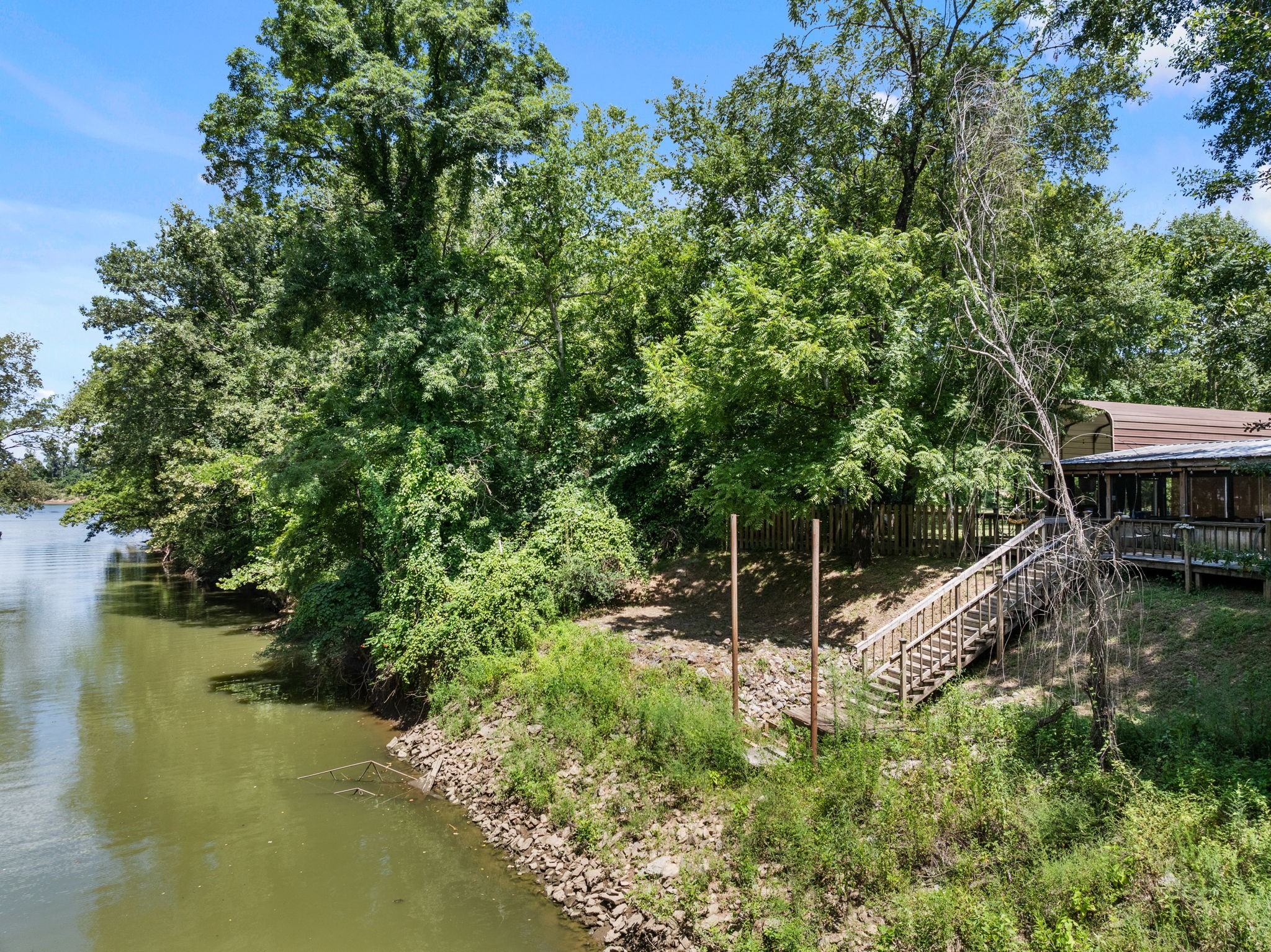85 Bargeview Lane Adamsville, TN 38310 - Photo 40 of 44 a backyard of a house with lots of green space and lake view