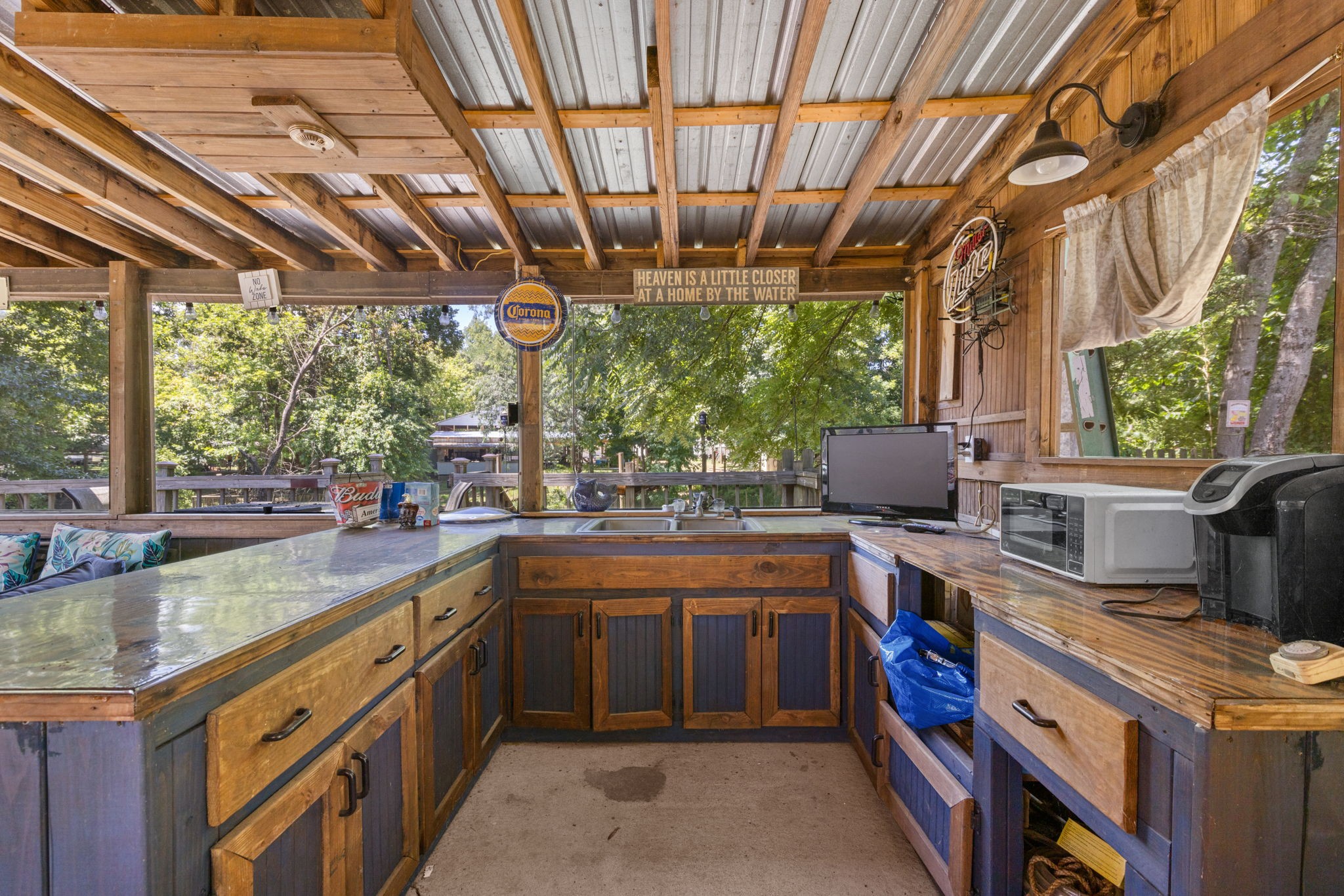 85 Bargeview Lane Adamsville, TN 38310 - Photo 7 of 44 a kitchen with stainless steel appliances granite countertop a sink a counter space a large window and cabinets
