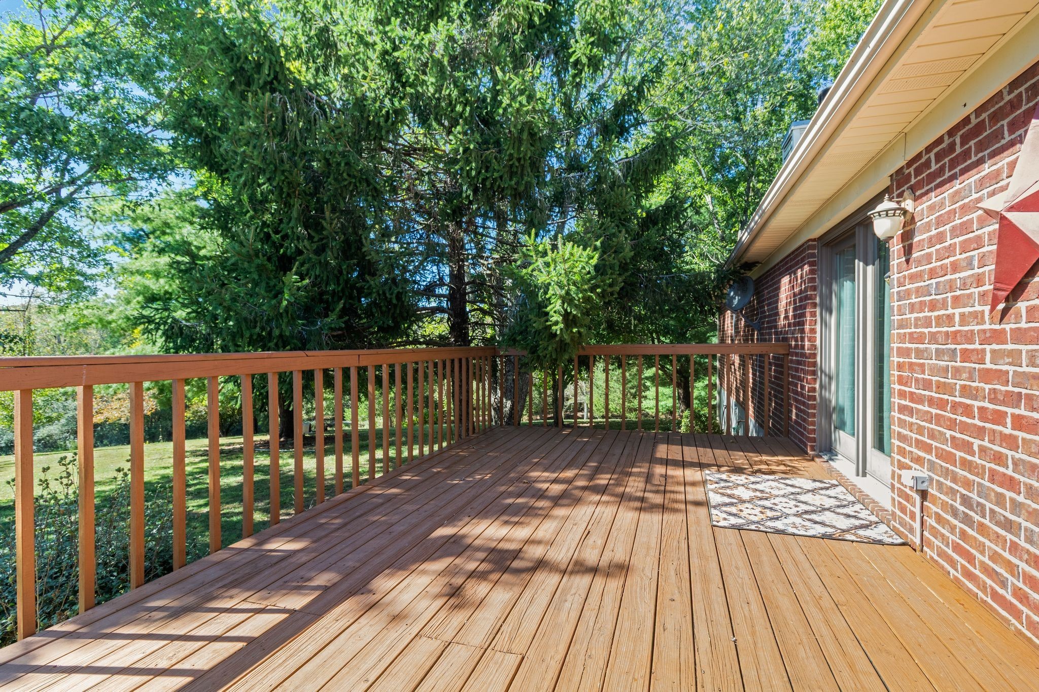 10373 Spanntown Road Arrington, TN 37014 - Photo 8 of 23 a view of a wooden deck with a large yard